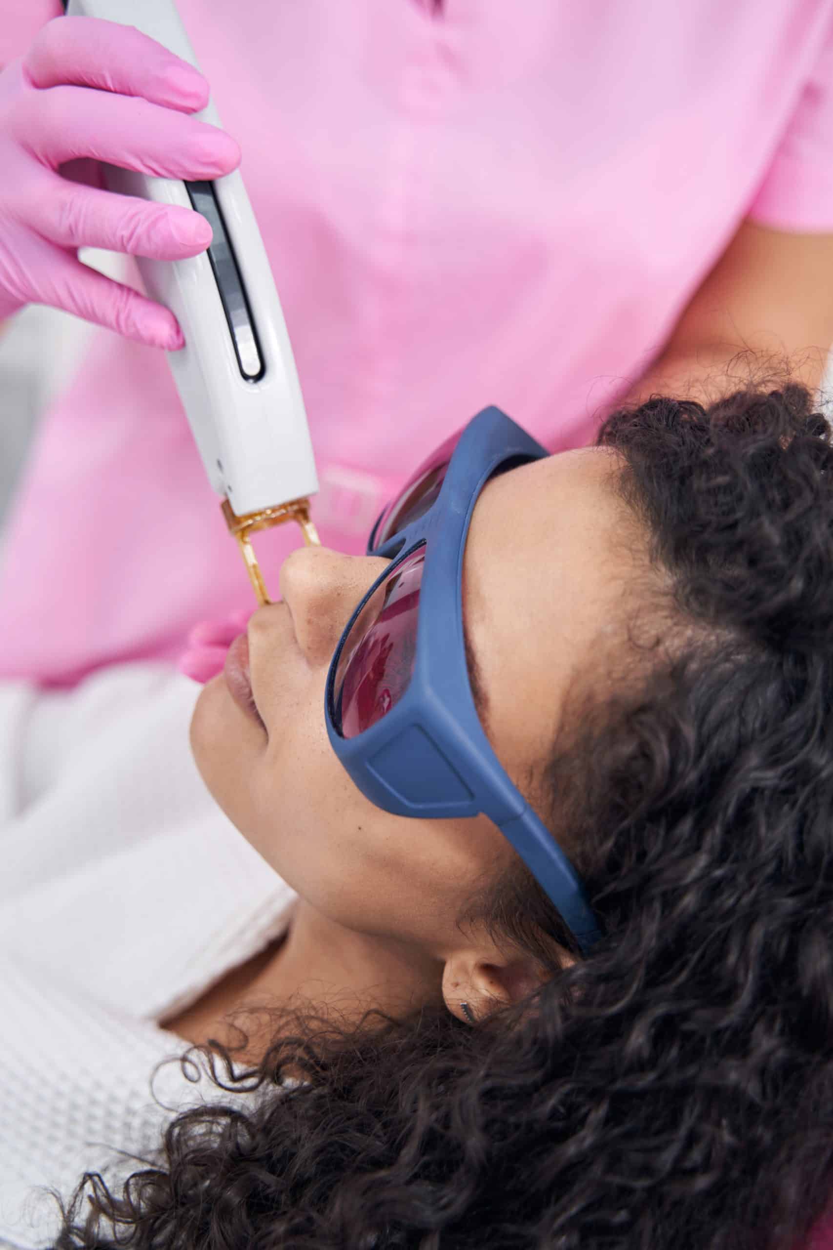 Aesthetic Medicine Doctor Holding A Laser Epilator On Female Face